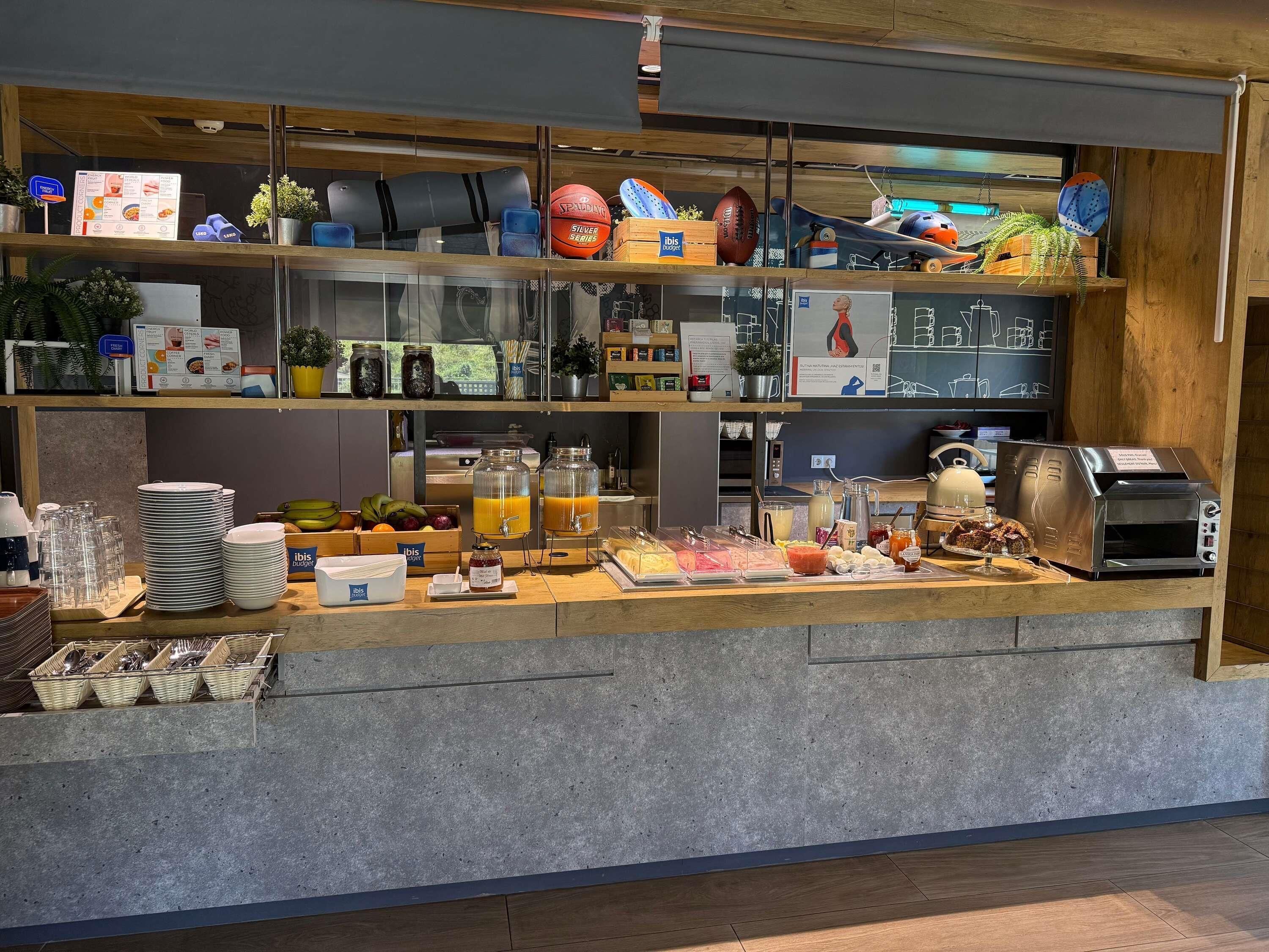 A breakfast bar with a coffee machine, toaster, and various food items.