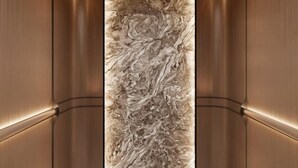 A modern elevator interior with a marble wall and metallic walls. - Ruili Hotel (Rui'an)