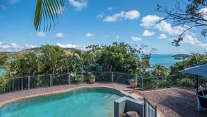 A swimming pool with a view of the sea and hills. - Heliconia 10 Hamilton Island - oceanviews, buggy and transfers (Hamilton Island)