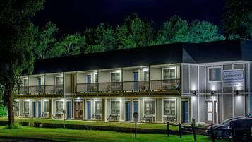 A motel with multiple rooms, a balcony on the second floor, and a sign for 'Gunnison Inn'.