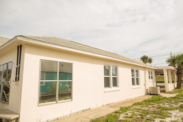 A single-story building with a flat roof, large windows, and a small attached garage. - Elizabeth's Memories - Beach Front (Panama City Beach)
