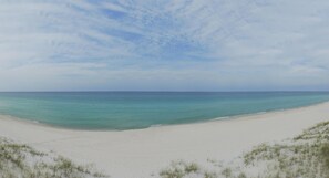 A beach with white sand and a clear blue sky. - Elizabeth's Memories - Beach Front (Panama City Beach)
