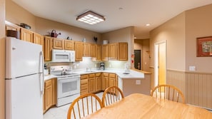 Enjoy cooking in this fully equipped kitchen with a refrigerator, stove, microwave, and sink.