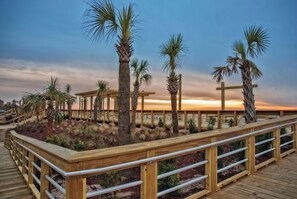 Stroll along the resort's scenic boardwalk, surrounded by palm trees and taking in the breathtaking views.
