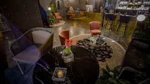 A modern bar area with a marble floor, bar stools, and a counter. - Noble Boutique Hotel - Adults Only (Budapest)