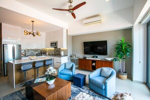 A modern living space with a kitchen, dining area, and seating. - Rooftop Pool, Gym & Hot Tub | Stylish 1BR Loft (Puerto Vallarta)