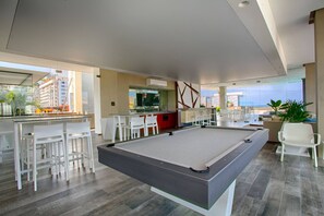A modern living room with a pool table, bar area, and seating. - Rooftop Pool, Gym & Hot Tub | Stylish 1BR Loft (Puerto Vallarta)