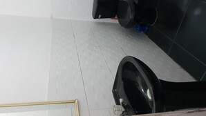 A bathroom with a toilet, a sink, and a mirror.