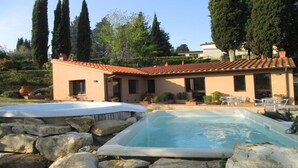A house with a swimming pool, surrounded by rocks and trees. - Farmhouse Il Colle (Bagno A Ripoli)