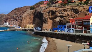 A coastal town with a rocky cliff, a pier, and buildings with balconies overlooking the sea. - Relax in front of the Ocean with a beautiful view! (Sardina del Norte)