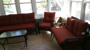 Relax in style on this patio with a sofa, armchairs, and a coffee table.