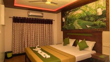 A hotel room with a bed, a painting, a ceiling fan, and a window with curtains.