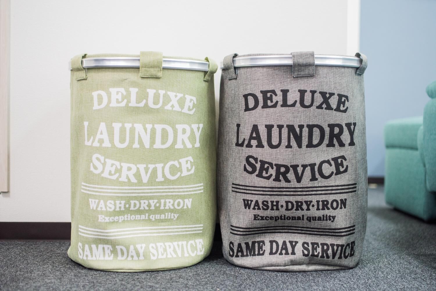 Two laundry service cans labeled 'Deluxe Laundry Service' with 'Wash, Dry, Iron' and 'Same Day Service'.