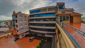 A multi-story building with a modern architectural design, featuring balconies and large windows. - Anoulackkhenlao Hotel (Phonsavan)