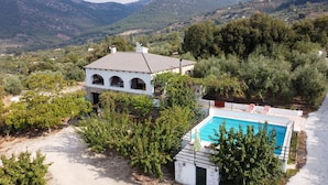 A villa with a swimming pool, surrounded by lush greenery and mountains. - Jurinea House Lift with private pool (TORRES)