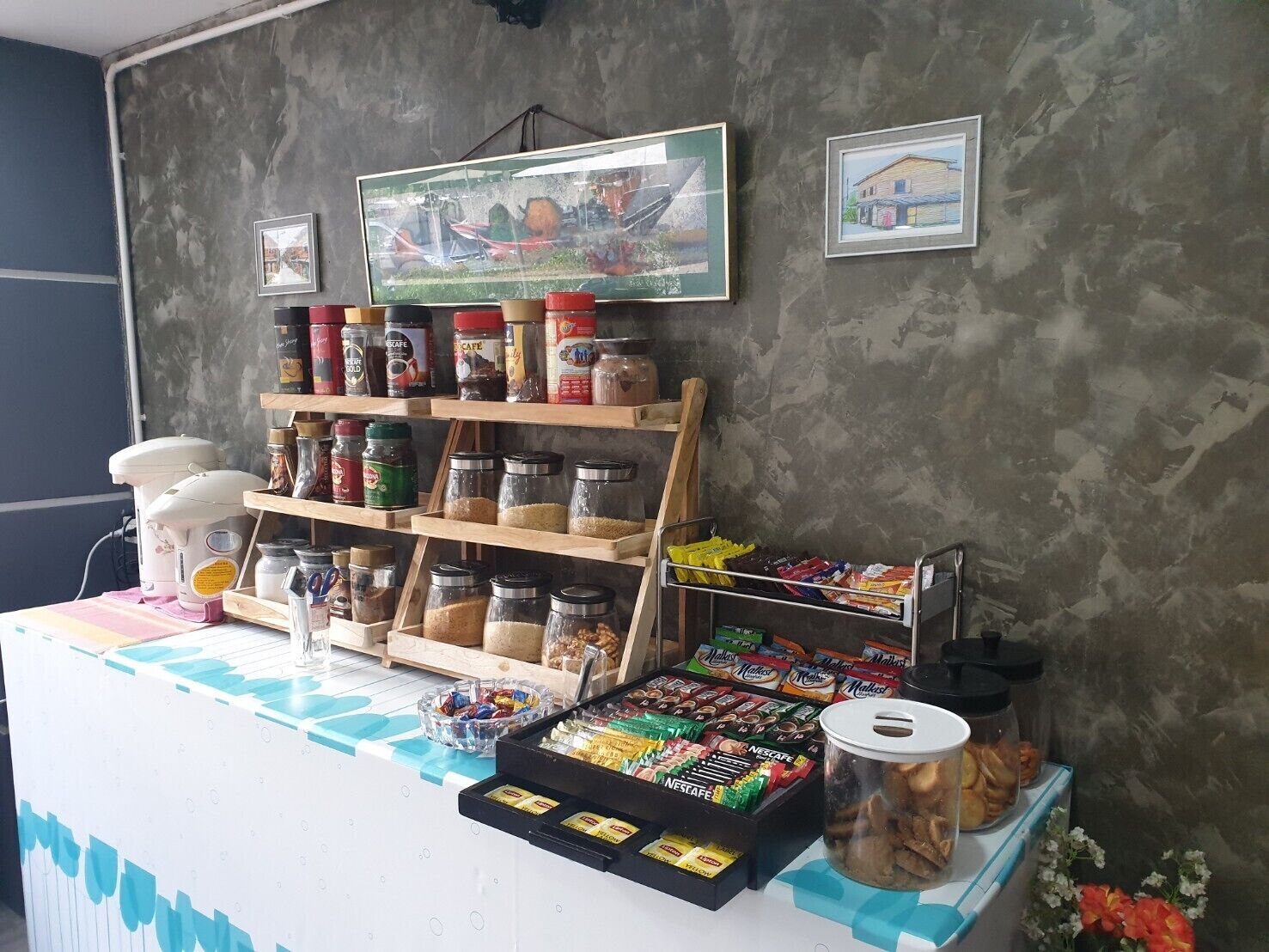A snack bar with jars of nuts, cereals, and packaged snacks.