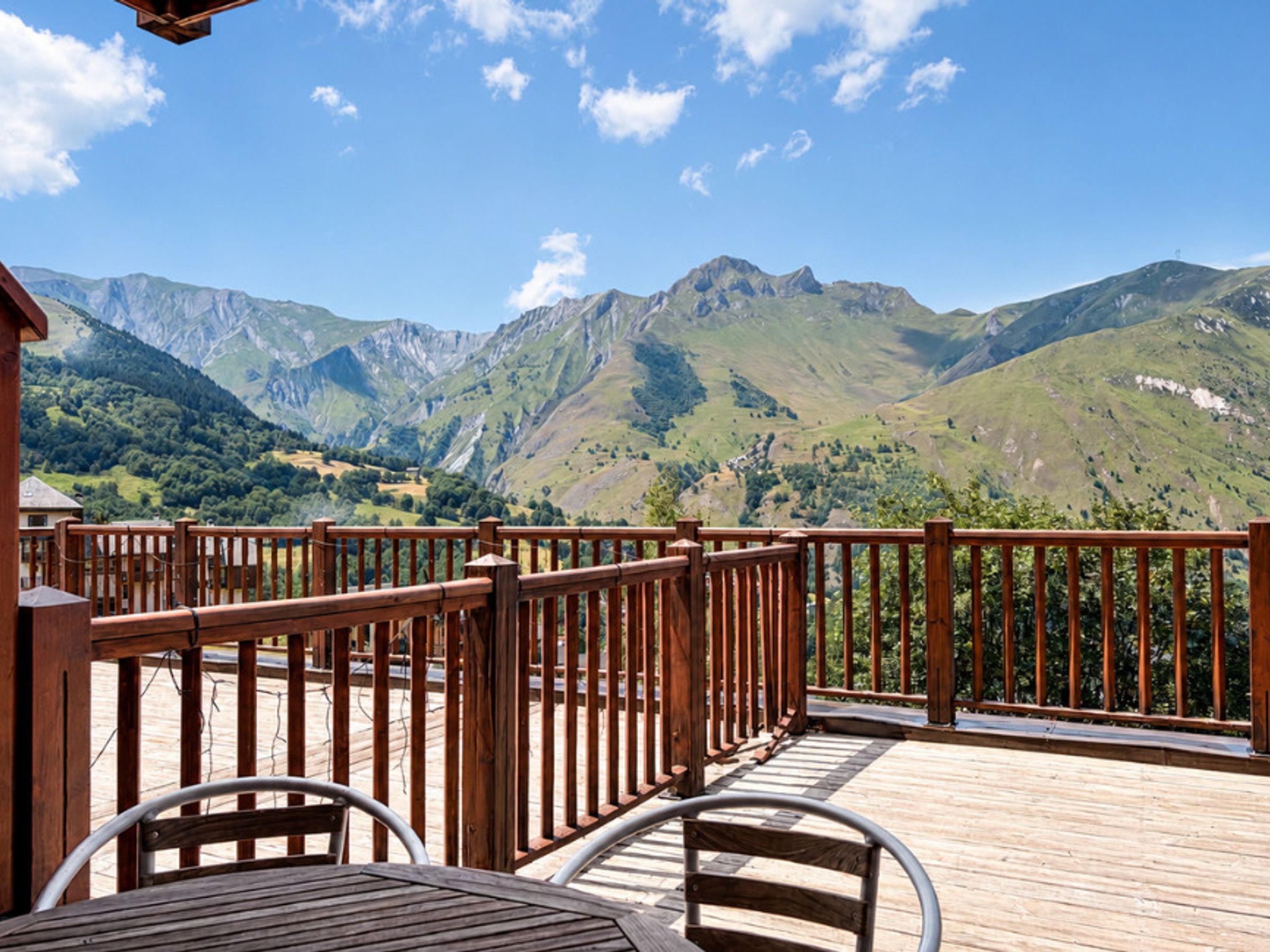 A wooden deck with a view of mountains.