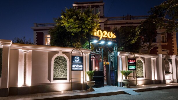 A hotel entrance with a neon sign reading "1920s Boutique Hotel & Restaurant." - 1920s Boutique Hotel and Restaurants (Cairo)