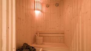 A wooden sauna with benches, a bucket, and a basket of stones. - 1920s Boutique Hotel and Restaurants (Cairo)