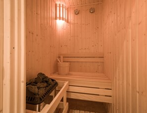 A wooden sauna with benches, a bucket, and a basket of stones. - 1920s Boutique Hotel and Restaurants (Cairo)