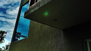 A multi-story building with a balcony and a large window. - Kings Landing Unawatuna (Unawatuna)
