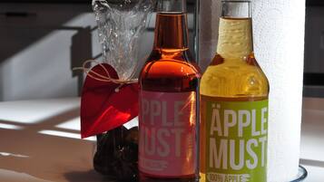 Three bottles of apple products on a table.