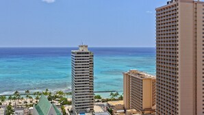 A high-rise hotel with a view of the ocean and beach.