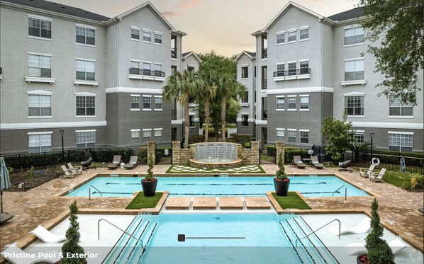 A residential building with a swimming pool and outdoor seating. - Spacious 2BR+2BA apartment in the hearth of Medical Center (Houston)