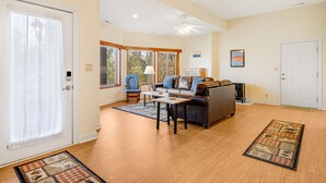 A spacious living room with a sofa set, a coffee table, and a fireplace. - Pisgah View Cabin - Year round Mountain View  - Convenient location (Hendersonville)
