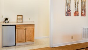 A kitchen with a refrigerator, a coffee maker, and a sign that says 'Enjoy LIFE Drink good BEER.' - Pisgah View Cabin - Year round Mountain View  - Convenient location (Hendersonville)
