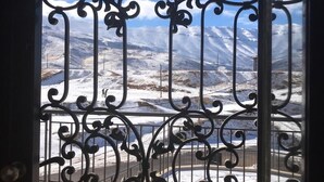 A balcony with ornate metal railings overlooking a snowy mountain landscape. - Chalet de Charme (Al Arz)