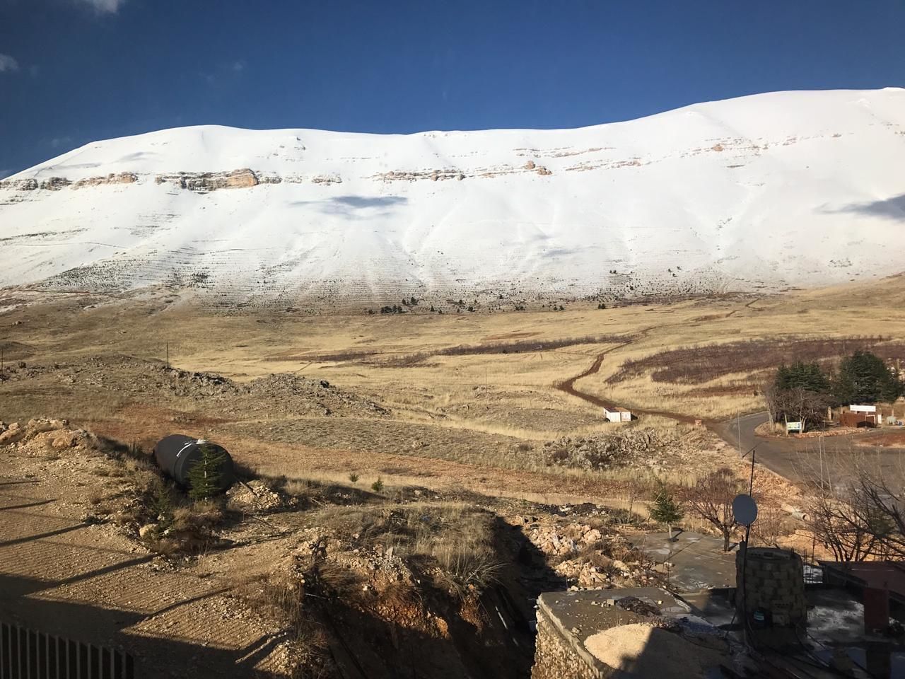 A snowy mountain landscape with a clear sky.