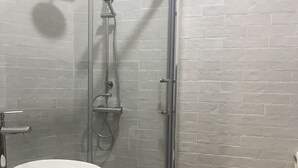 A modern bathroom with a glass-enclosed shower, a white sink, and a toilet. - Terrazza Carlo terzo (Naples)