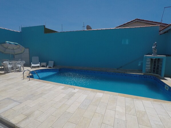 Outdoor pool, open 9:00 AM to 9:00 PM, pool loungers