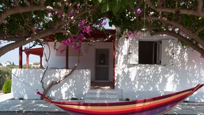 A white building with a red wooden porch, a door, and a window. - Felicia s sun-side house, Cycladic house by the beach, true owner hospitality (Naxos)
