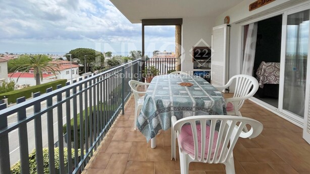 A balcony with a table and chairs, a view of the city, and a sign with the number 22.