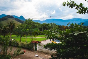 Escape to a serene haven surrounded by lush greenery and breathtaking views of the surrounding hills and mountains.