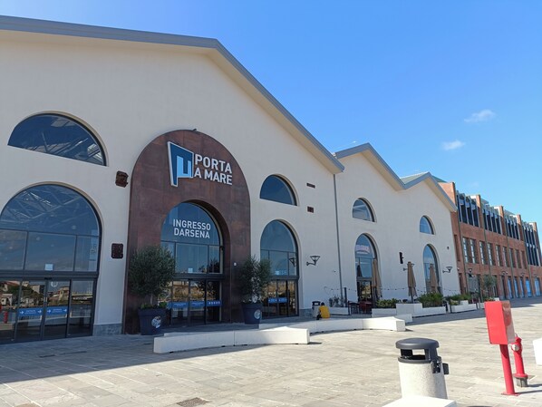 A building with a sign reading "Porta Mare" and "Ingresso Darsena".