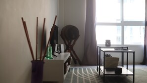A living room with a sofa, a coffee table, a side table, a chair, a lamp, and a window with curtains. - Exposito's Vacation Home  (Las Palmas de Gran Canaria)
