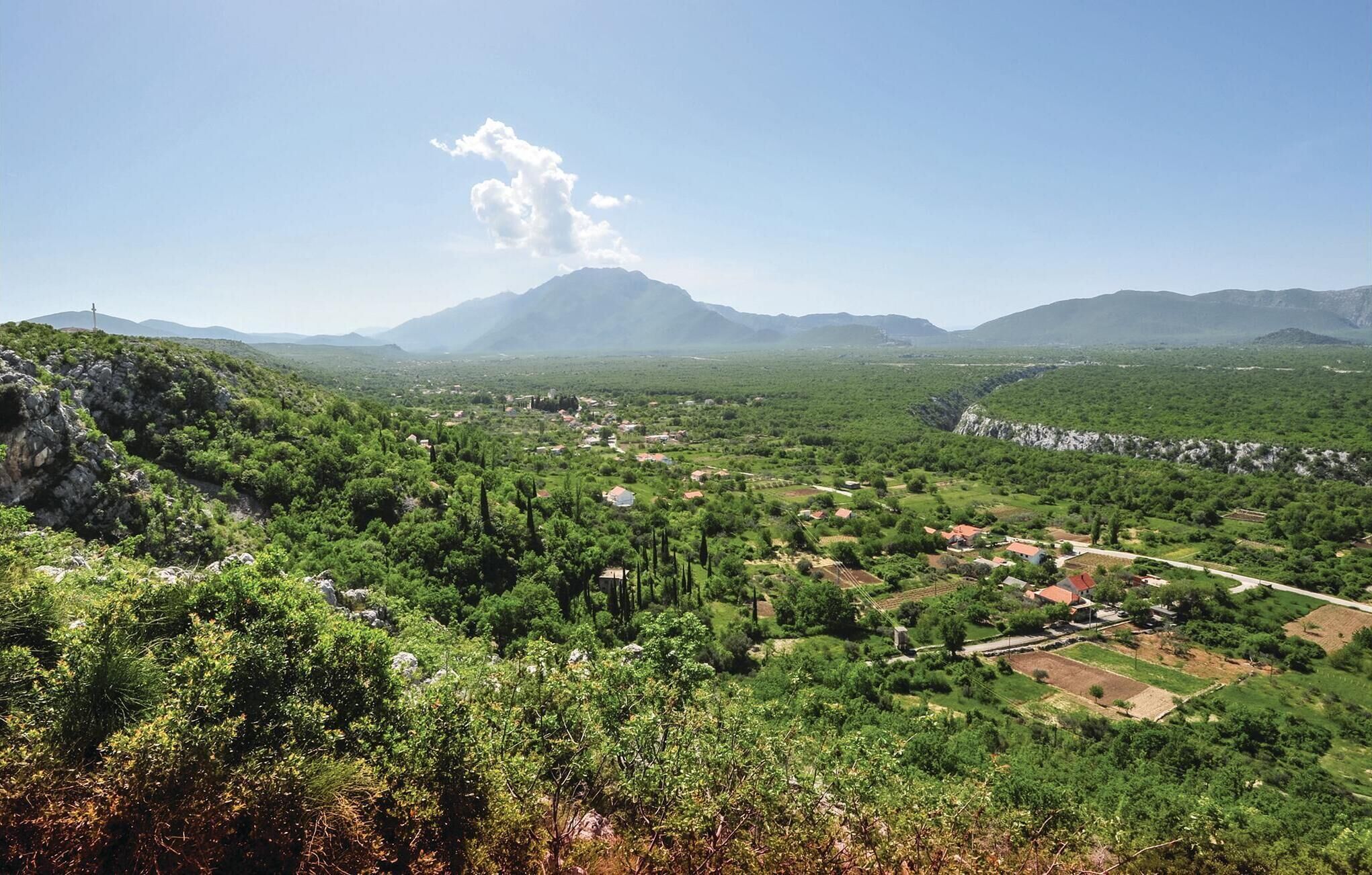 A mountainous landscape with a village nestled in the valley.