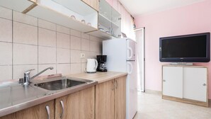 A modern kitchen with a sink, coffee maker, and a flat-screen TV on a stand. - 1 bedroom gorgeous apartment in Matulji (Matulji)
