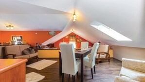 A cozy attic room with a dining area, a sofa, and a small kitchen area. - Beautiful apartment in Hreljin with WiFi (Hreljin)