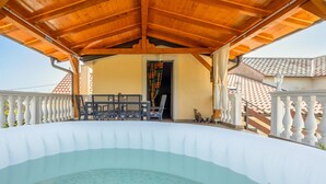 A covered outdoor swimming pool with a wooden ceiling and white balustrades. - Beautiful apartment in Hreljin with WiFi (Hreljin)