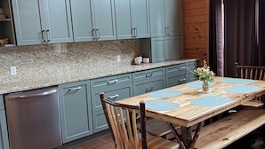 A wooden interior with a kitchen, dining table, chairs, and a bench. - Nature lovers paradise w/direct access to lake,  trails & ample trailer parking. (Atlanta)