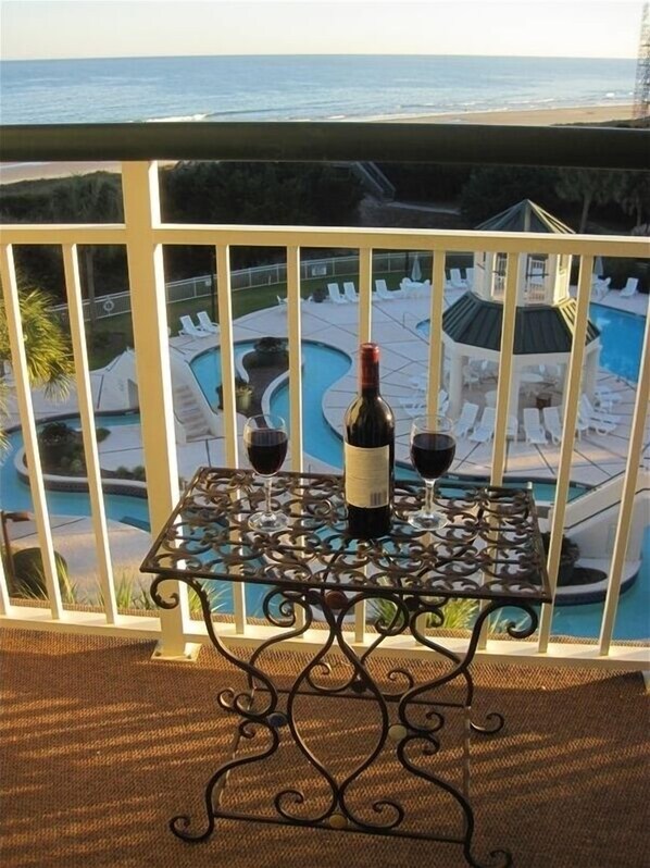 Enjoy a drink with a view from this balcony overlooking the pool and ocean.