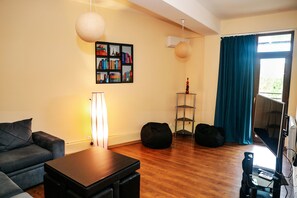 Apartment, 1 Bedroom, City View | Living area | Flat-screen TV