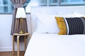 A neatly made bed with white bedding and a single yellow and black striped pillow. - S1 Awesome 1BR near KLCC - KL Tower - Hi Speed WIFI (Kuala Lumpur)