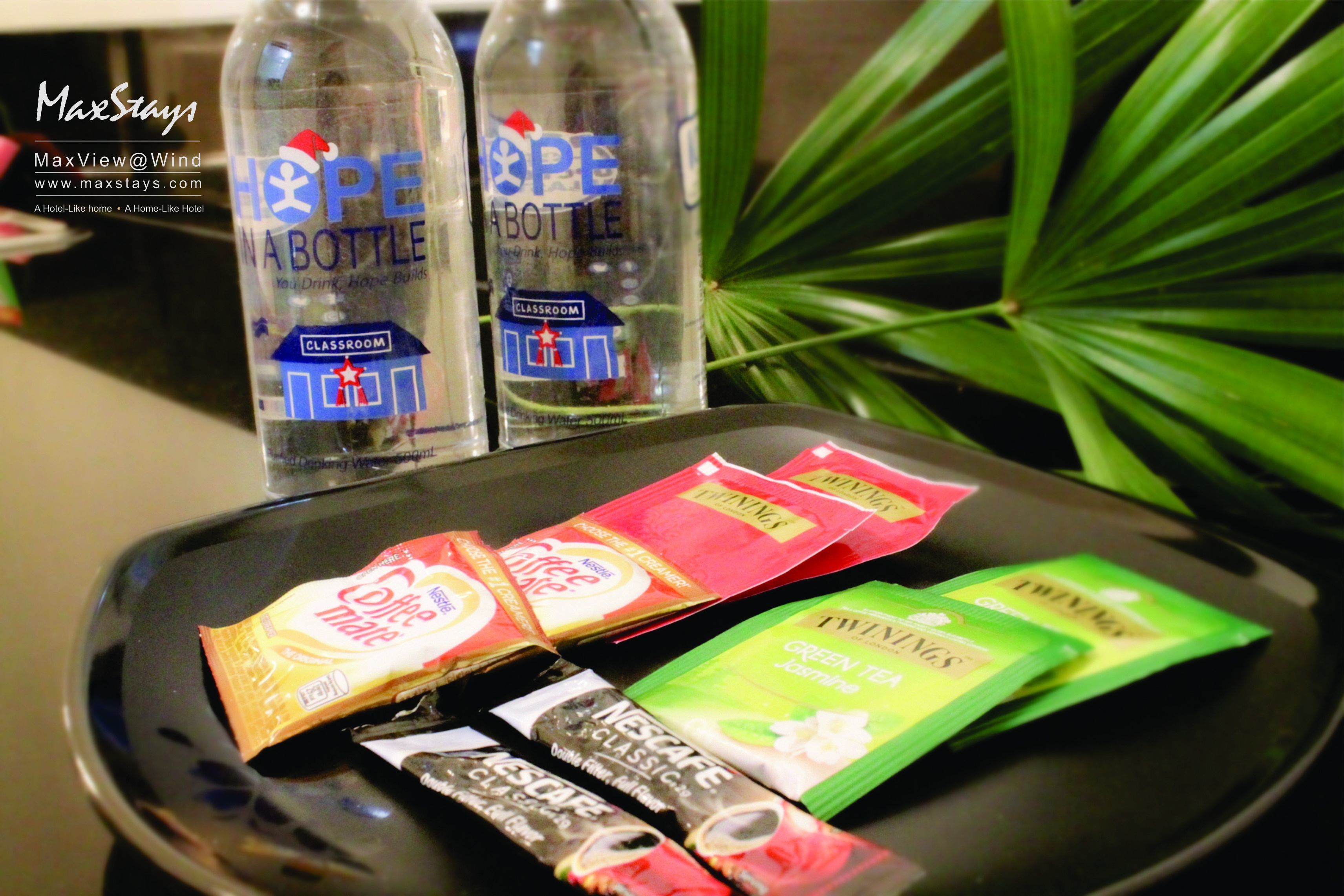 A tray with two bottles labeled "Hope in a Bottle" and several packets of snacks.