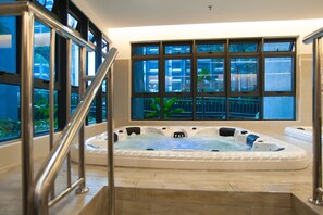 A large indoor hot tub with a view of a balcony and plants. - A3 FAMILY Suites 4-6pax Jonker Melaka (Malacca City)