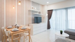 A modern living room with a dining area, a flat-screen TV, and a sofa. - S6 Beautiful 2 Beds Suite - KLCC - KL Tower - WIFI (Kuala Lumpur)